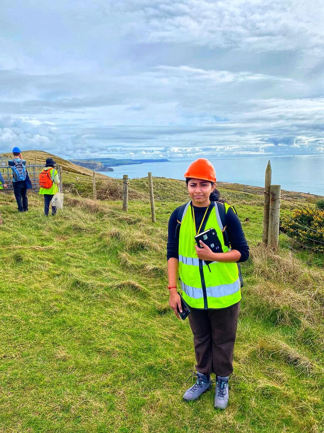 Gouri in field safety gear on the coast